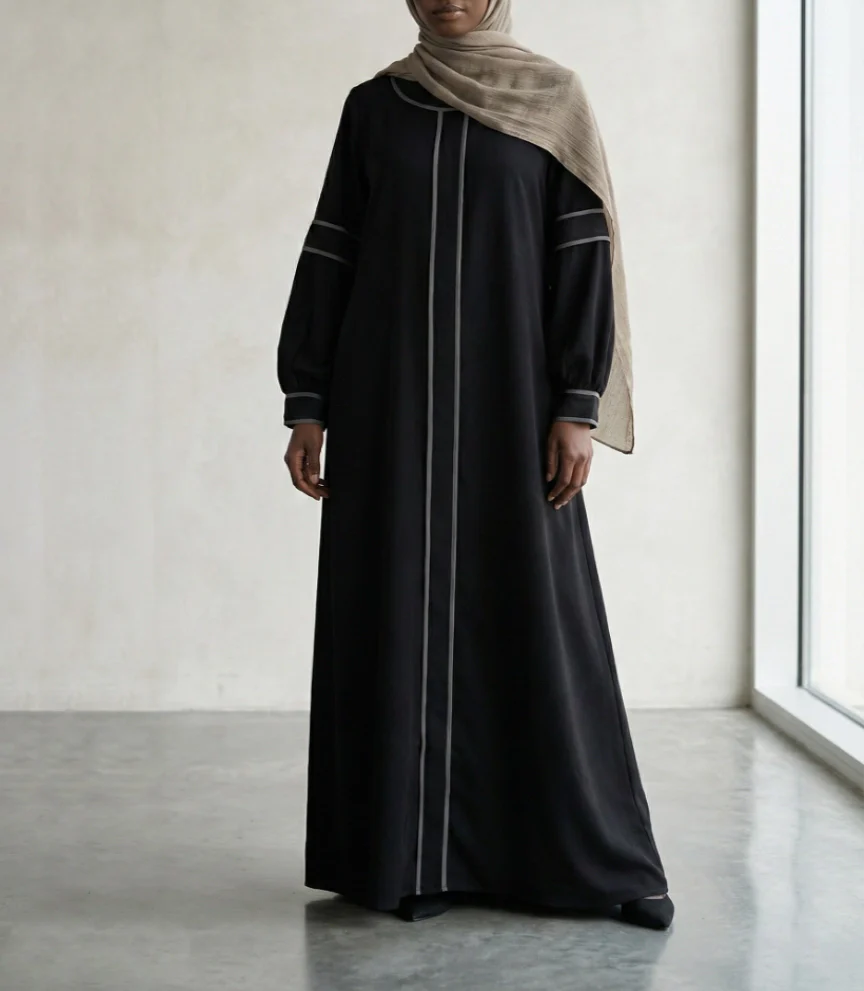 Woman in black abaya with grey piping