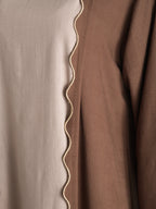 Close-up of brown fabric with a wavy edge