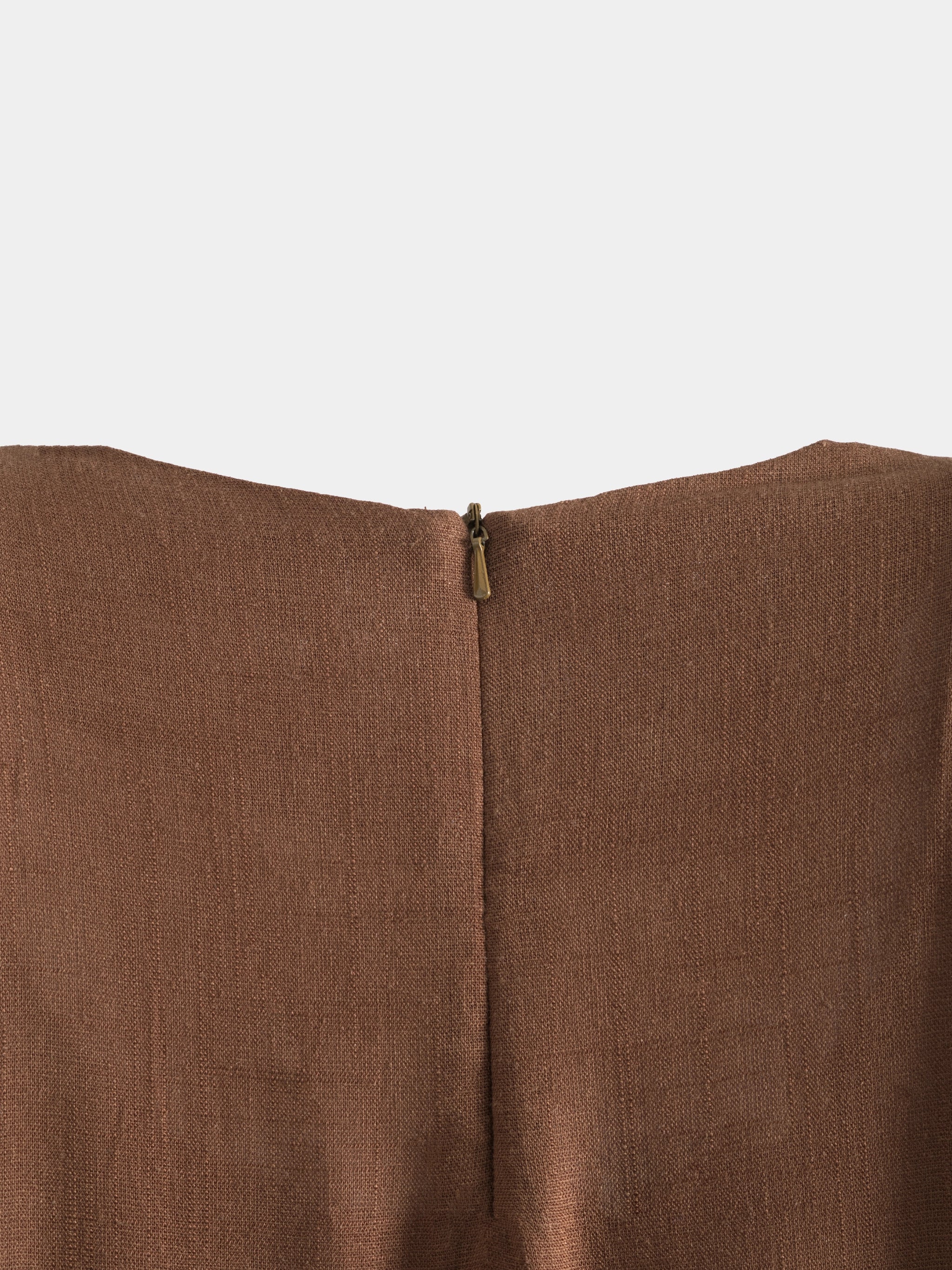 Brown fabric with a zipper detail on a white background