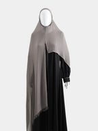 Full-length view of the Taupe Instant Hijab paired with a black abaya, demonstrating the 100% opaque drape and shoulder coverage.