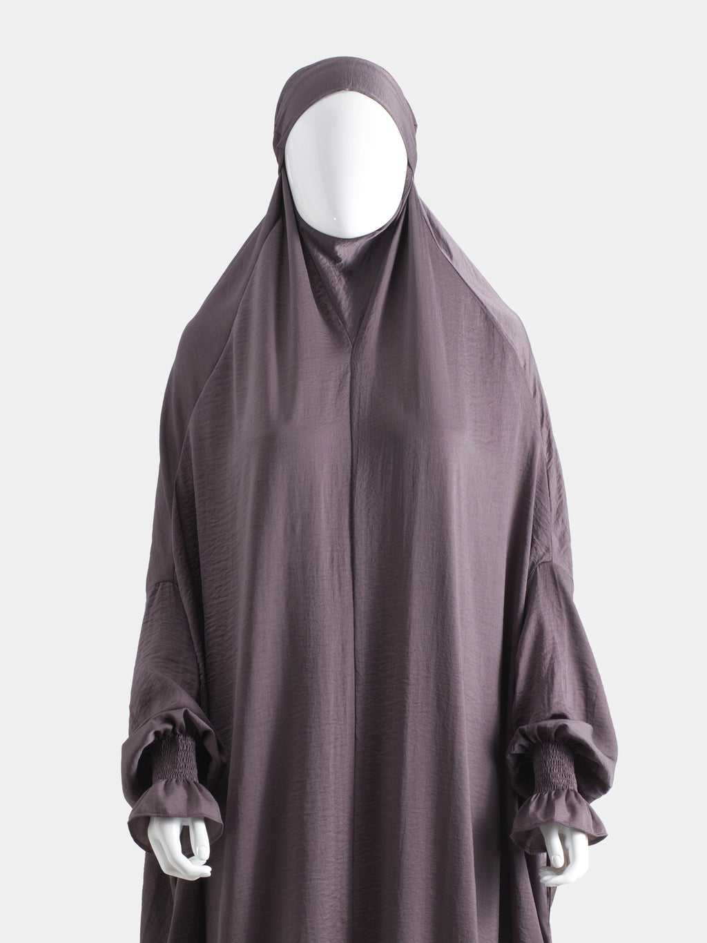 Dark purple jilbab on a mannequin against a white background