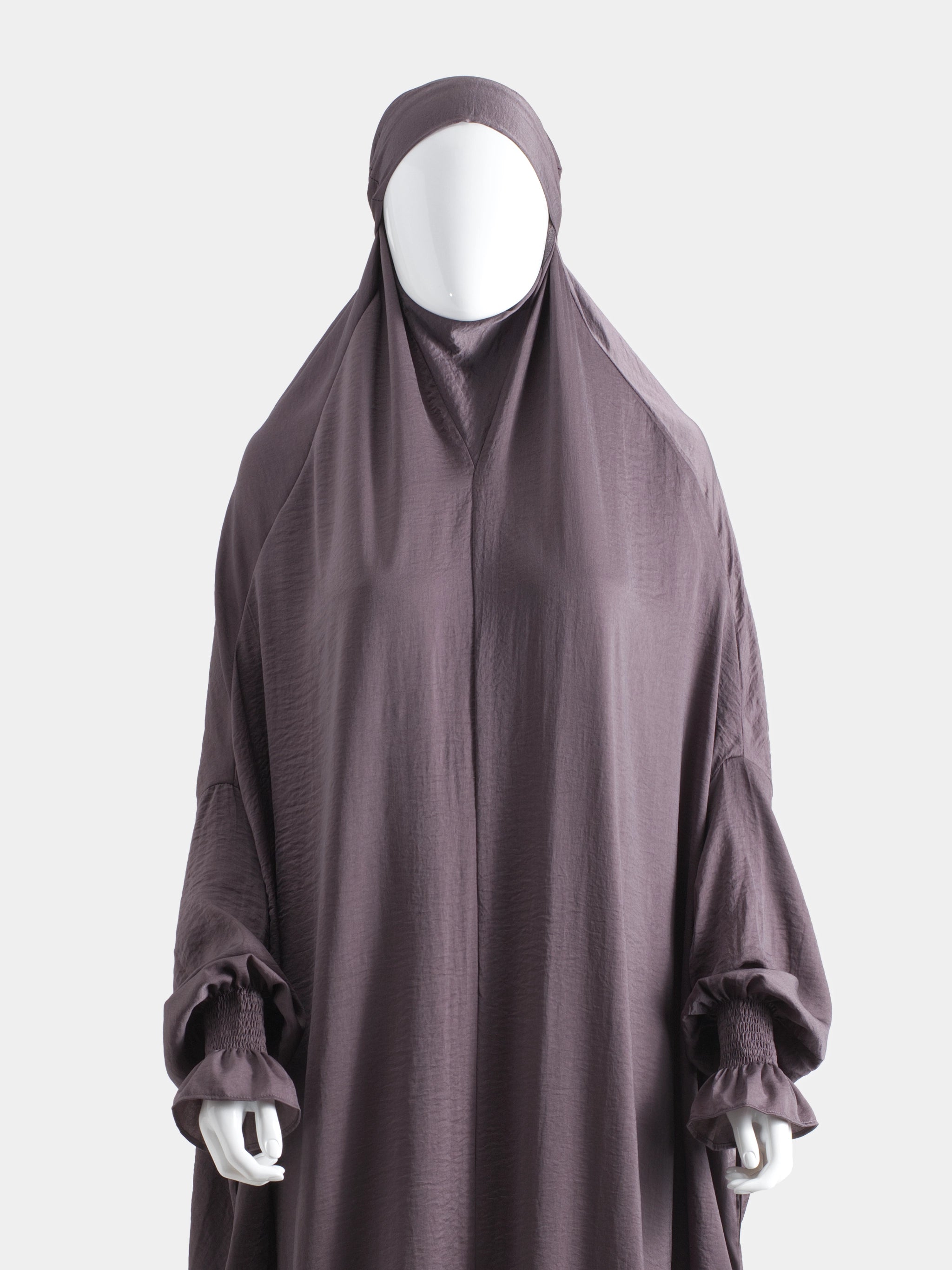 Dark purple jilbab on a mannequin against a white background