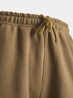 Close‑up of taupe cotton fleece lounge pants waistband with hidden drawstring