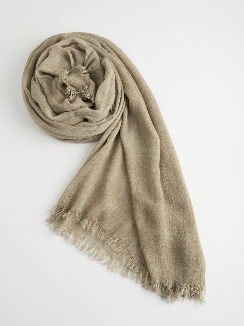 Textured crinkle beige scarf with frayed edges on a white background