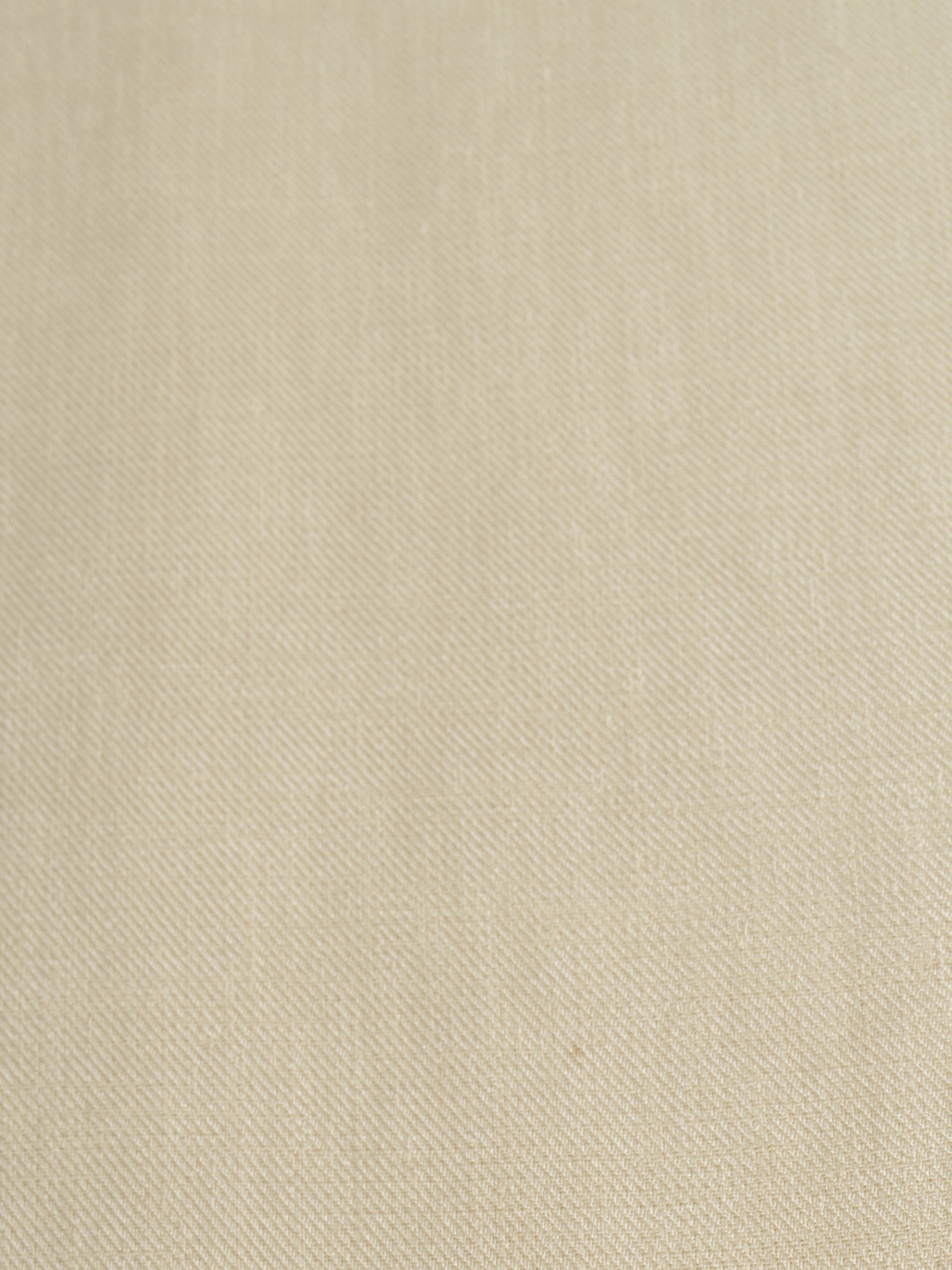Close-up of Creme palazzo pants showing the texture of the soft fabric for the modest, wide-leg cut.