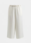 Front view of Ivory wide-leg palazzo pants made of soft crepe fabric featuring a high-rise elasticated waistband for a modest fit.
