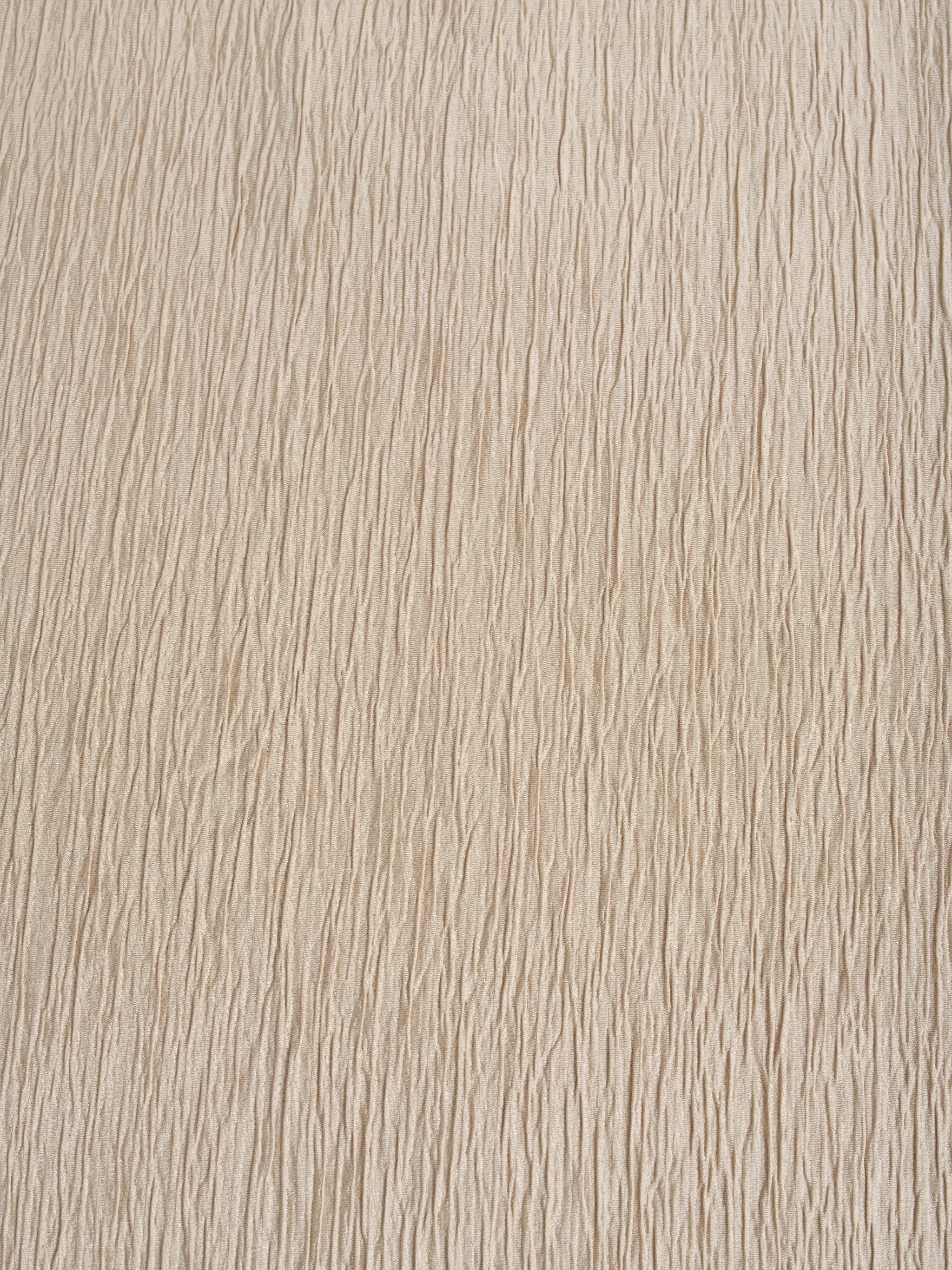 Close-up of Beige wide-leg palazzo pants showing the refined vertical texture of the premium crepe fabric and the modest, wide-leg cut