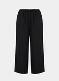 Front view of black textured cotton wide-leg palazzo pants featuring a modest, flowy silhouette and comfortable elasticated waistband.
