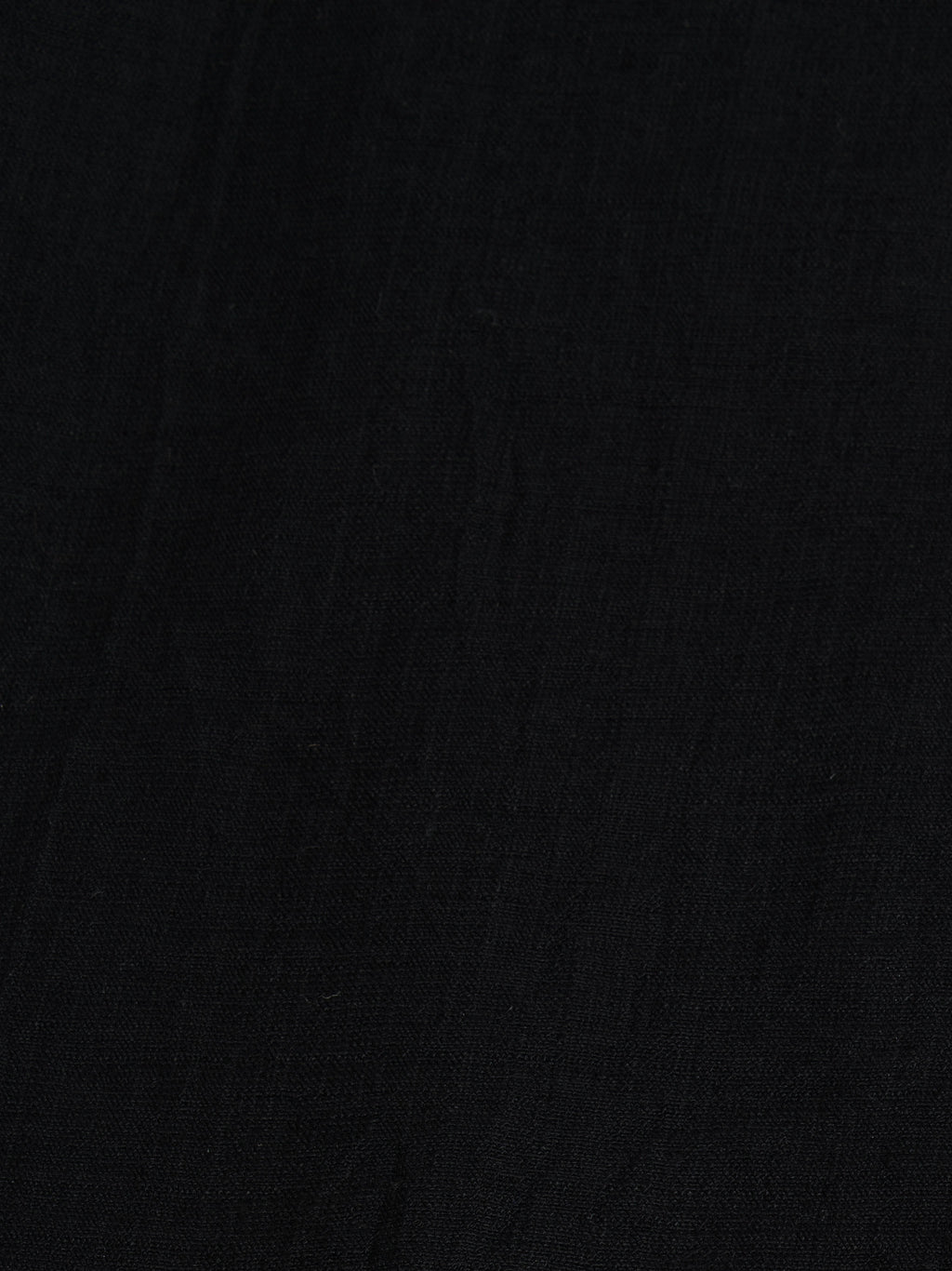Close-up of Black palazzo pants showing the texture of the textured cotton fabricfor the modest, wide-leg cut.